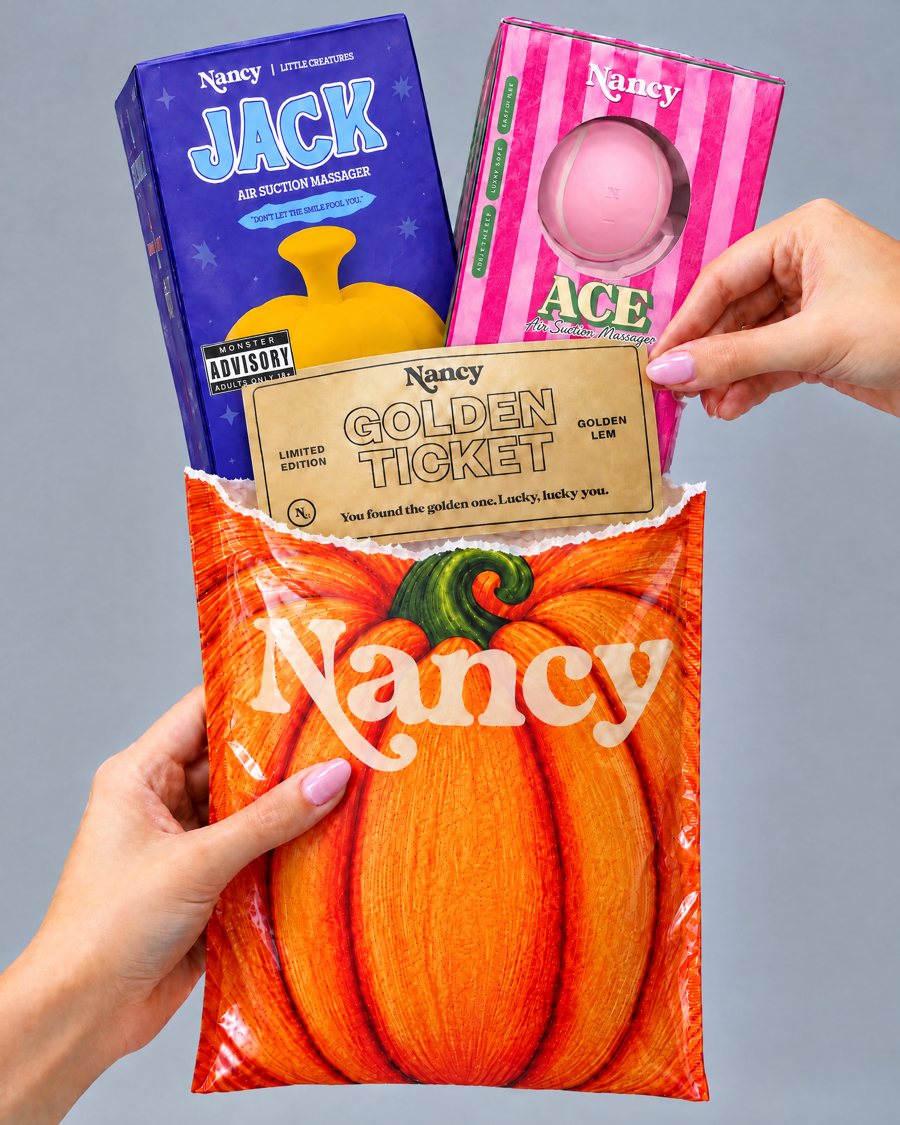Hands pulling a gold box out of the Nancy pumpkin bag